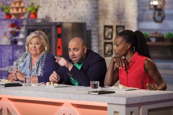 Judge Duff Goldman, center, comments on a vanilla bean cake prepared by Najie Mercedes during the "Berry Naked Cake" main-heat challenge, as seen on Food Network's Spring Baking Championship, Season 2.
